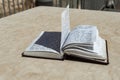 The open  holy book of Jews with the text of prayers in Hebrew - Tehelim, lies on a table near the Western Wall in the old city. Royalty Free Stock Photo