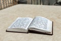 The open  holy book of Jews with the text of prayers in Hebrew - Tehelim, lies on a table near the Western Wall in the old city. Royalty Free Stock Photo