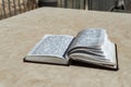 The open  holy book of Jews with the text of prayers in Hebrew - Tehelim, lies on a table near the Western Wall in the old city. Royalty Free Stock Photo