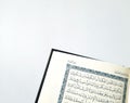 Open Holy Qur'an on a white table Royalty Free Stock Photo