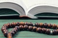 The Open holy Quran with tasbih rosary beads close up