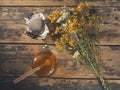 Open honey jar with drained flowers Royalty Free Stock Photo