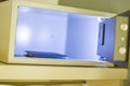 Open hotel room safe with a wallet inside, ensuring security for valuables. Royalty Free Stock Photo