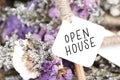 Open house word on card and purple flower background