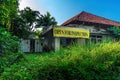 Open for Inspection Plastic Sign Banner in Front of Empty Damage Abandoned House Building with Unattended Garden Full of Grass and