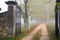 Open iron gate on foggy path