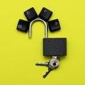 Open iron padlock with keys on a yellow background on the lock lever the keys of the computer keyboard are lined with the Royalty Free Stock Photo