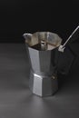 Open italian coffee maker, brewing coffee, black background