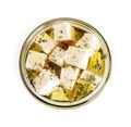 Open jar with feta cheese marinated in oil on background, top view. Pickled food