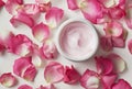 Open Jar of Luxurious Rose-Scented Cream Surrounded by Fresh Pink Petals Royalty Free Stock Photo