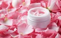 Open Jar of Luxurious Rose-Scented Cream Surrounded by Fresh Pink Petals Royalty Free Stock Photo