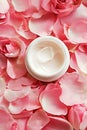 Open Jar of Luxurious Rose-Scented Cream Surrounded by Fresh Pink Petals Royalty Free Stock Photo