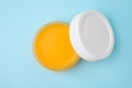 Open jar of petrolatum on light blue background, top view Royalty Free Stock Photo