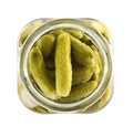 Open jar with pickled gherkins on white, top view Royalty Free Stock Photo