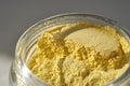 An open jar of a yellow turmeric facial scrub showing off its texture. Royalty Free Stock Photo