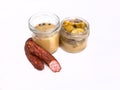 Open jars of pickled cucumbers and smoked sausage, isolated. Pickles and a meat product, banner with a copypace. Snacks