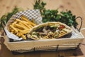 Open Kebab with fries and some greens in Basket
