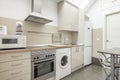 Open kitchen of an apartment with bright cream cabinets, stainless Royalty Free Stock Photo