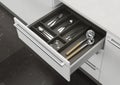 Open kitchen drawer with cooking utensils. Storage and organization of the kitchen. Royalty Free Stock Photo