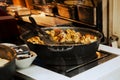 Open kitchen of restaurant or cafe in Vienna, Europe. Big black frying pan with traditional Viennese Kaiserschmarrn