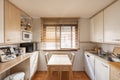 open kitchen with wooden cabinets, windows with wooden shutters Royalty Free Stock Photo