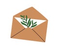 Open kraft envelope with paper letter, greeting card and leaf plant. Mail, post with postcard and natural decoration Royalty Free Stock Photo