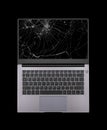 open laptop with a broken, cracked screen isolated on black background Royalty Free Stock Photo