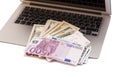 Open Laptop With Dollars And Euro money Royalty Free Stock Photo