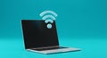 Open laptop with floating wifi symbol on cyan background Royalty Free Stock Photo