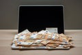 Open laptop and pile of money euro banknotes Royalty Free Stock Photo