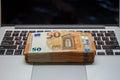 Open laptop and stacks of money euro banknotes Royalty Free Stock Photo