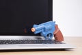 Open laptop with toy pistol