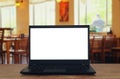 open laptop with white screen in front of abstract blurred restaurant lights background Royalty Free Stock Photo