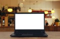 open laptop with white screen in front of abstract blurred restaurant lights background Royalty Free Stock Photo