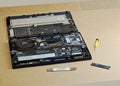 An open laptop on a workbench with its back cover removed, internal components m.2 NVME SSD upgrade in progress, tools pry spudger Royalty Free Stock Photo