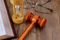 Open law book with a wooden judge's gavel on table in a courtroom or law enforcement office Royalty Free Stock Photo