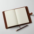 Open leather-bound notebook on a white surface, featuring blank cream-colored pag Royalty Free Stock Photo