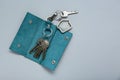 Open leather holder with keys on light grey background, top view. Space for text Royalty Free Stock Photo