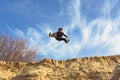 Open-leg jump from sand Royalty Free Stock Photo
