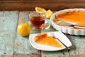 Open lemon pie, tea, fresh lemons and peels on shabby turquoise Royalty Free Stock Photo