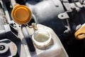 Open lid on an antifreeze tank. Dusty details of a flat-four boxer car engine compartment under the open hood Royalty Free Stock Photo