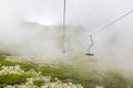 The open lift moves effortlessly through low clouds