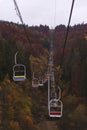 Open lift to the mountains among the autumn forest