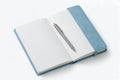 Open light blue notebook with lined pages and silver pen on white background lined paper Royalty Free Stock Photo