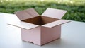 Open Pink Cardboard Box on White Surface with Green Bokeh Background Royalty Free Stock Photo