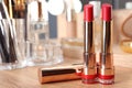 Open lipsticks in gold tubes on dressing table Royalty Free Stock Photo