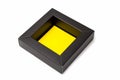 An open little black cardboard box with a yellow bottom. Isolated mockup on white background