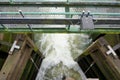 Open lock gates letting out water from the river. March 2021 Royalty Free Stock Photo