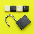 open lock on a yellow background the word open concept is laid out on top of a computer keyboard Royalty Free Stock Photo