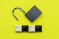 Open lock on a yellow background the word open concept is laid out from the bottom of the computer keyboard Royalty Free Stock Photo